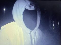 Momento em que trabalhadores municipais mascarados derrubam bandeiras da Union Jack na escuridão da noite